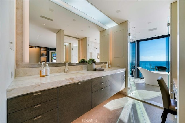 bathroom with a water view, vanity, plus walk in shower, and expansive windows