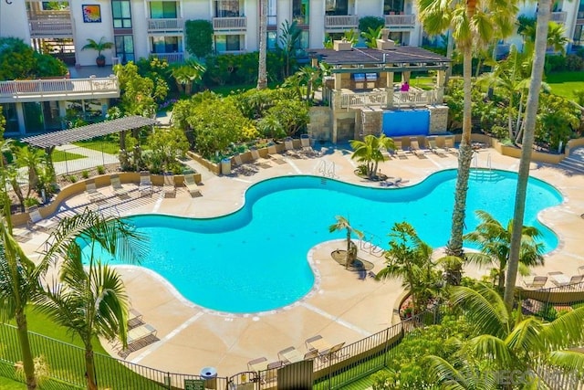 view of pool featuring a bar and a patio