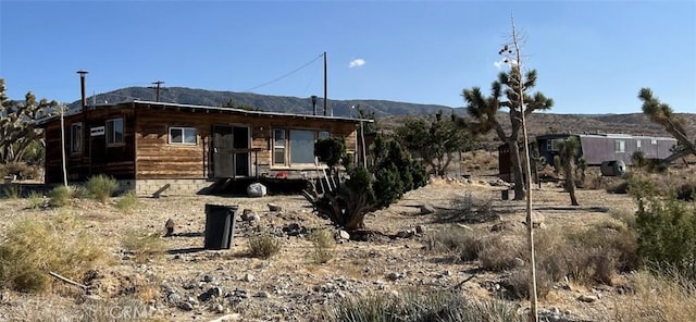 rear view of property with a mountain view