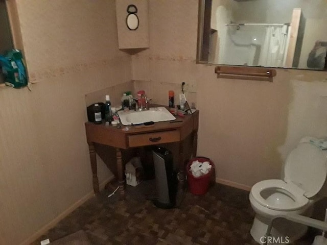 bathroom with a shower, toilet, and sink