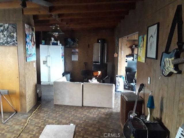 living room with beam ceiling and wooden walls