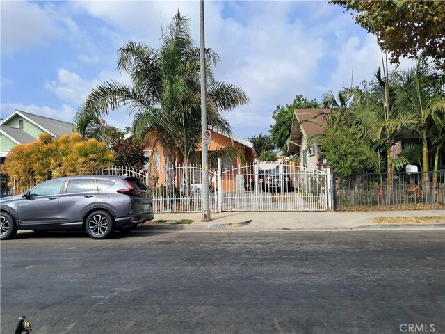 1227 Rolland Curtis Pl Unit 1227-1/2, Los Angeles, CA 90037 - view of property hidden behind natural elements featuring a gate