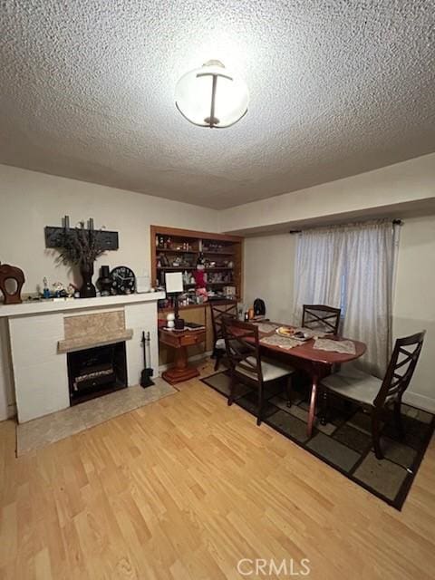 dining area with a textured ceiling and hardwood / wood-style flooring