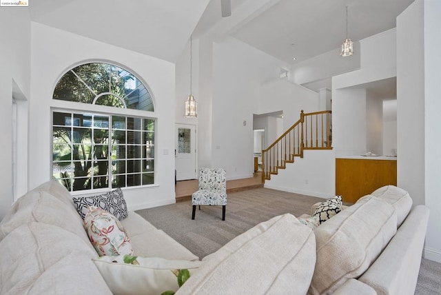 carpeted living room with high vaulted ceiling