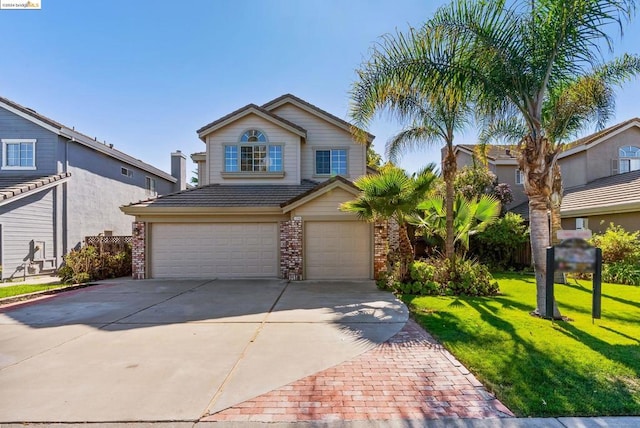 view of front of property with a garage and a front lawn