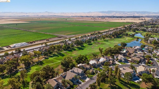 birds eye view of property with a water and mountain view