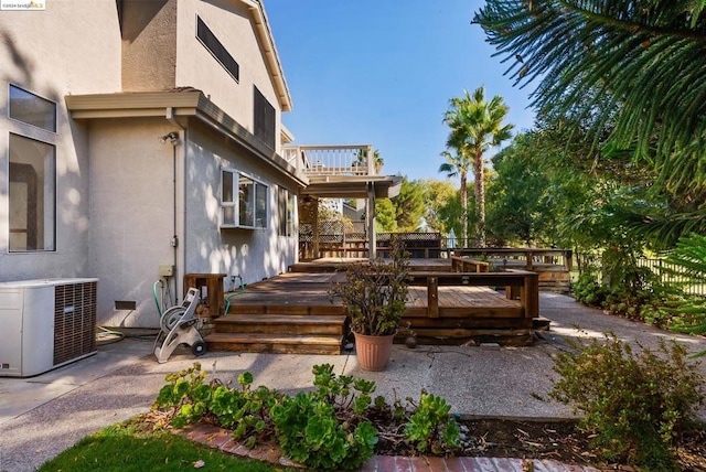 exterior space with a deck and central AC