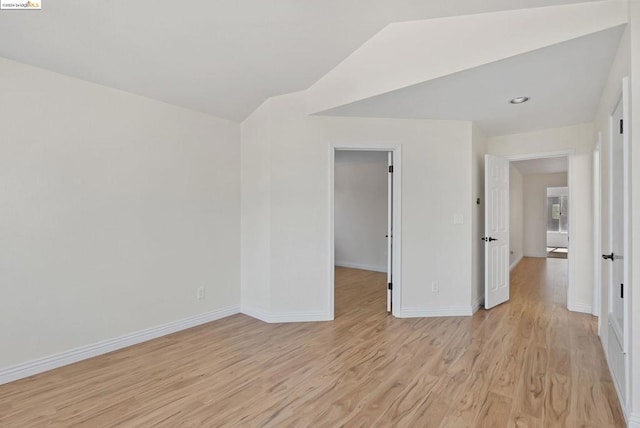 empty room with light hardwood / wood-style flooring