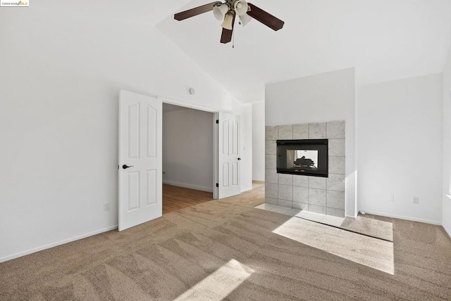 unfurnished living room featuring a fireplace, light colored carpet, high vaulted ceiling, and ceiling fan