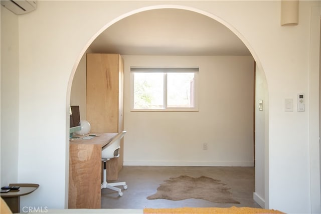 carpeted office space featuring a wall mounted AC