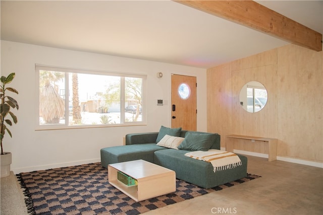 carpeted living room featuring beamed ceiling