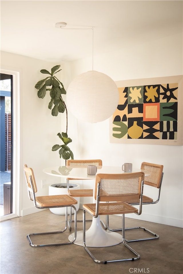 dining area featuring concrete floors