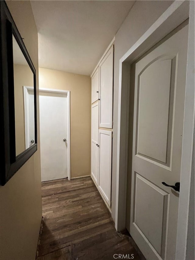 corridor with dark hardwood / wood-style floors