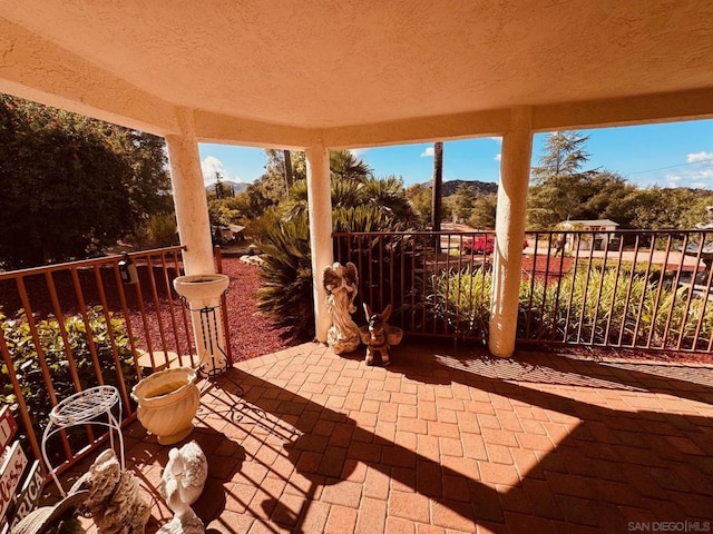 view of patio featuring a balcony