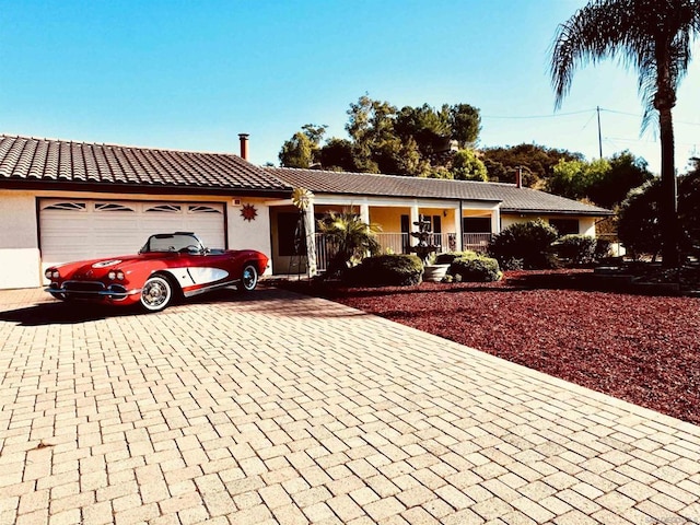 ranch-style house featuring a garage and a porch