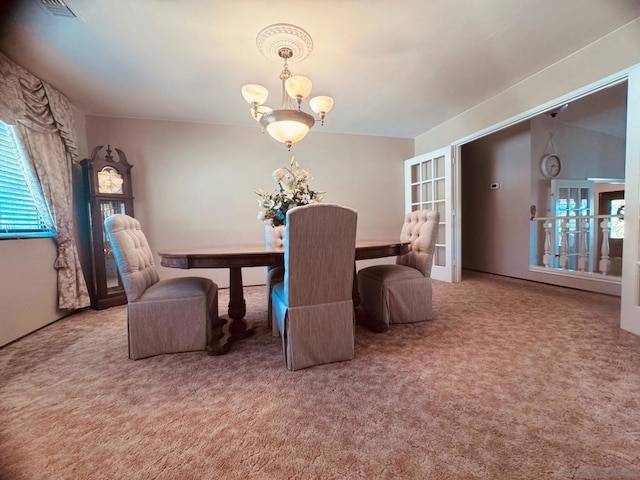 carpeted dining area featuring a notable chandelier