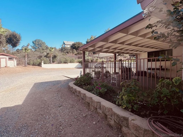 view of patio featuring a storage unit