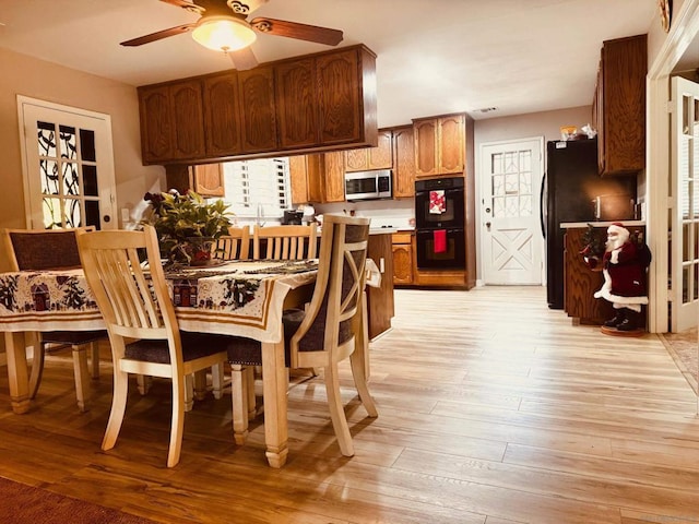 kitchen with ceiling fan, light wood-type flooring, and black appliances