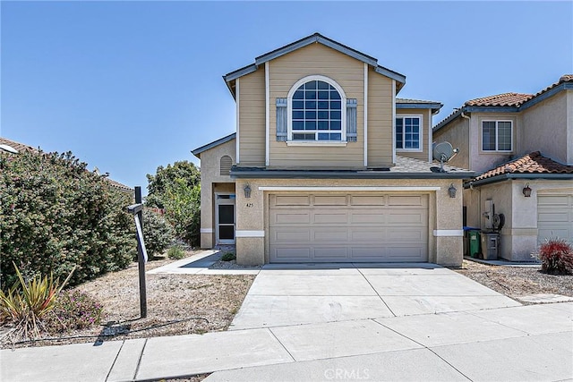 425 Bakeman Ln, Arroyo Grande, CA 93420 - view of front of property featuring a garage, driveway, and stucco siding