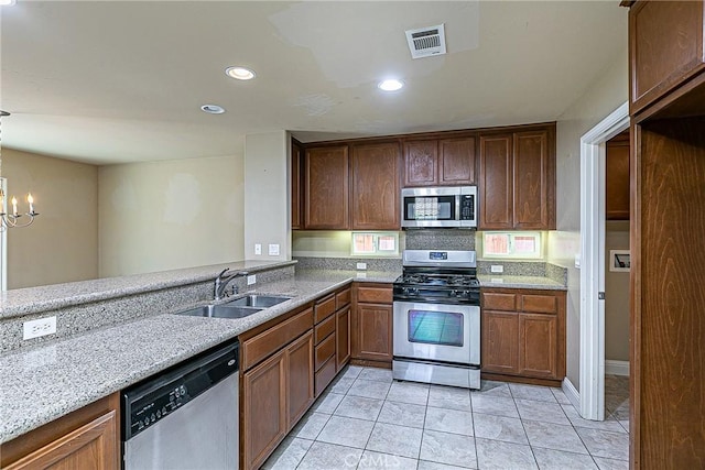 425 Bakeman Ln, Arroyo Grande, CA 93420 - kitchen featuring stainless steel appliances, light stone countertops, light tile patterned floors, a chandelier, and recessed lighting