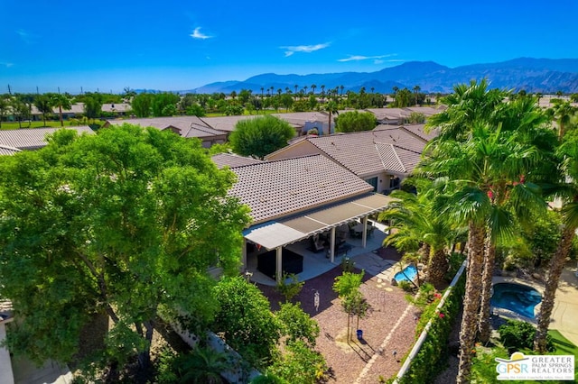 birds eye view of property with a mountain view