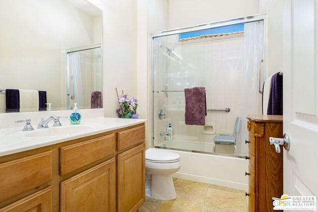 full bathroom featuring tile patterned flooring, toilet, vanity, and combined bath / shower with glass door