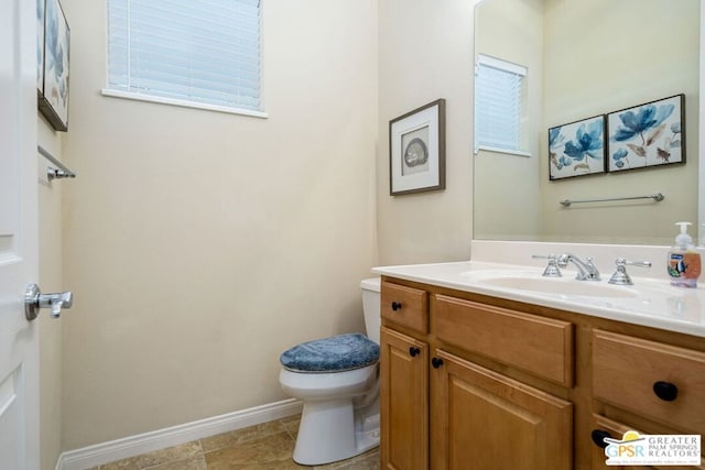 bathroom featuring vanity and toilet