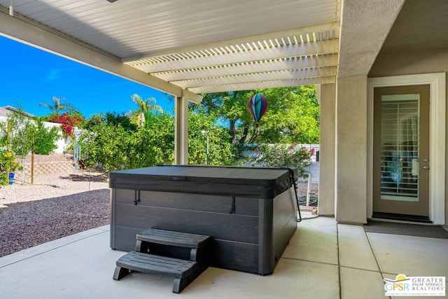 view of patio / terrace with a pergola and a hot tub