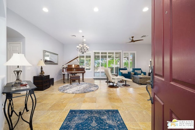 entrance foyer featuring ceiling fan with notable chandelier