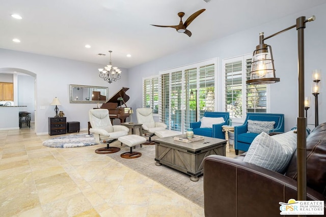 living room featuring ceiling fan with notable chandelier