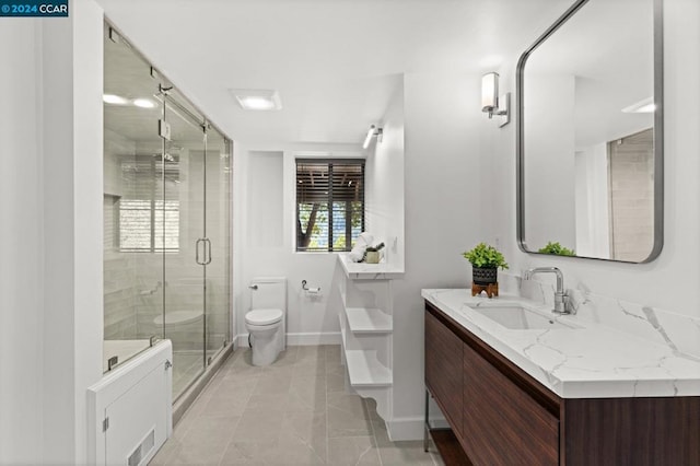 bathroom featuring toilet, an enclosed shower, and vanity