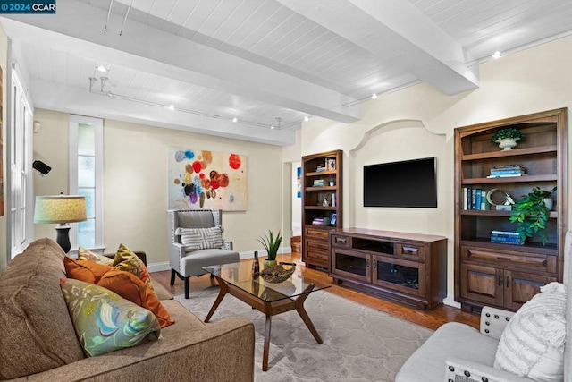 living room with rail lighting, beamed ceiling, and light wood-type flooring