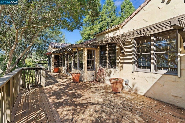 view of side of home with a deck and a pergola