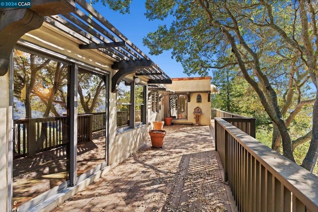 deck featuring a patio and a pergola