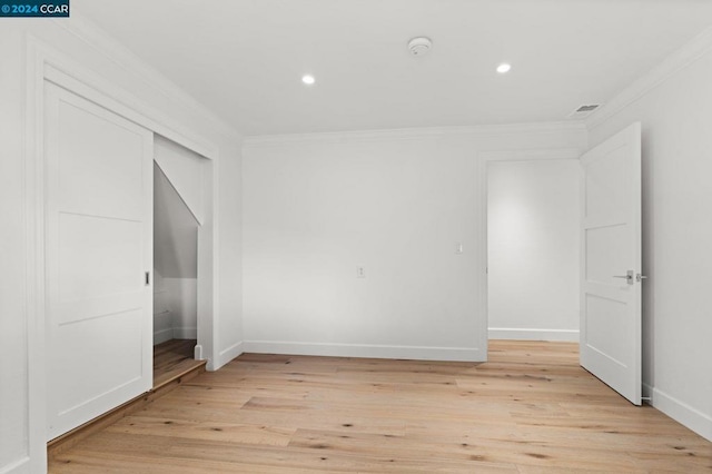 unfurnished bedroom featuring light hardwood / wood-style floors and ornamental molding