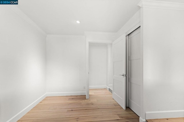 interior space with ornamental molding and light wood-type flooring