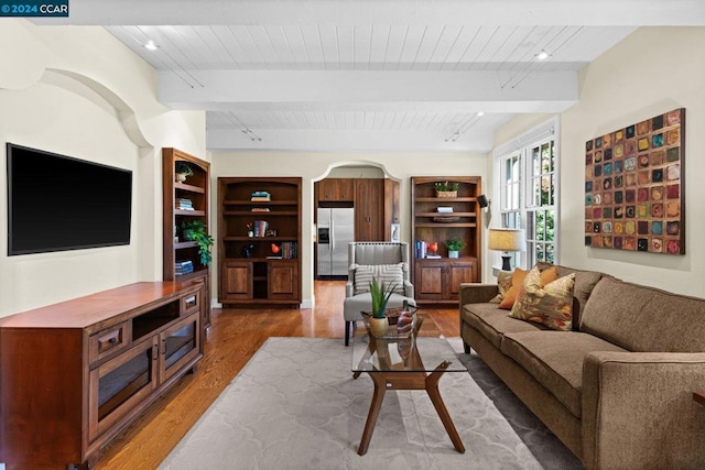 living room with beamed ceiling and wood-type flooring