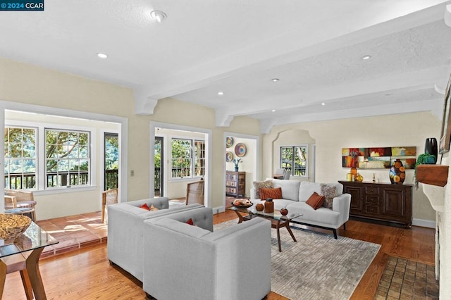 living room with beam ceiling and hardwood / wood-style floors