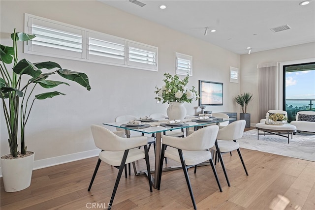 dining space featuring light wood-type flooring