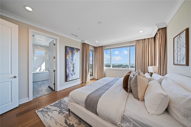 bedroom featuring ornamental molding, ensuite bathroom, and hardwood / wood-style flooring