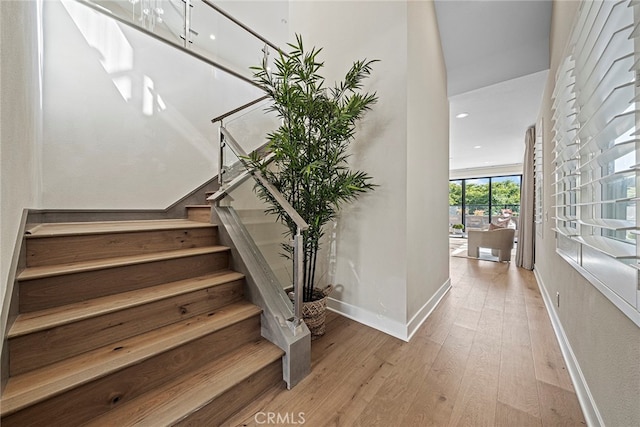 stairway featuring wood-type flooring