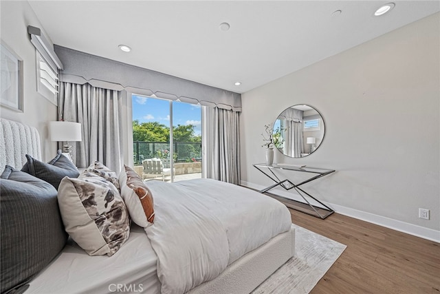 bedroom with hardwood / wood-style flooring and access to exterior