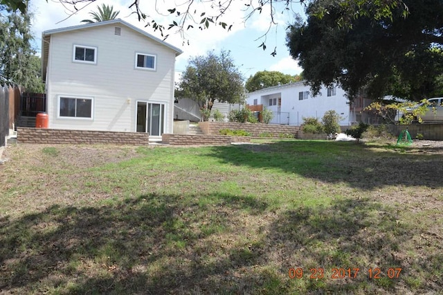 rear view of house with a lawn