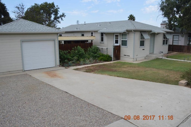 ranch-style house with a garage and a front lawn