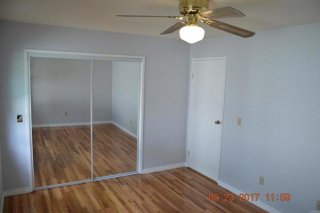 unfurnished bedroom featuring a closet, ceiling fan, and hardwood / wood-style floors