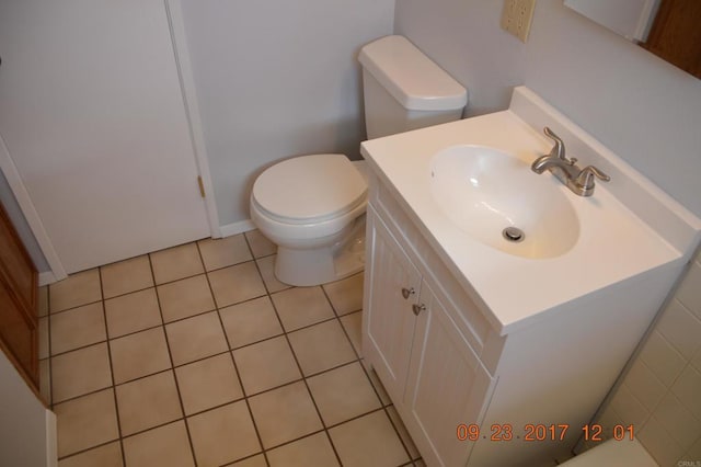 bathroom with vanity, toilet, and tile patterned flooring