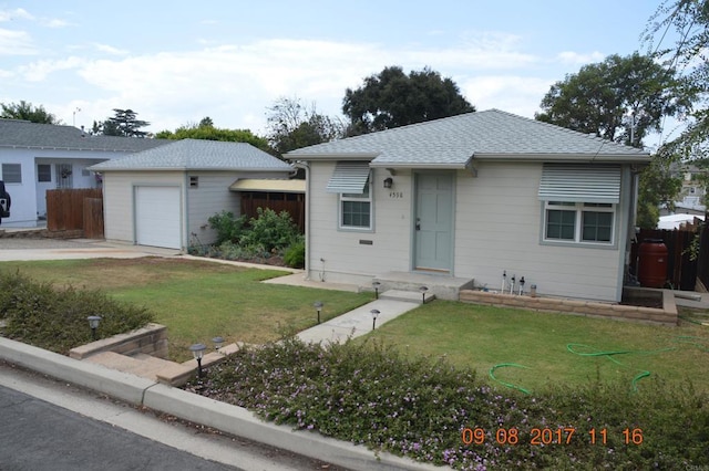 ranch-style house with a front yard and a garage