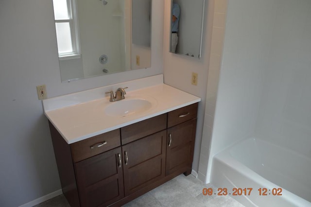 bathroom featuring vanity,  shower combination, and tile patterned flooring