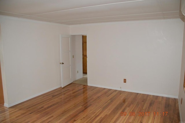 spare room with wood-type flooring