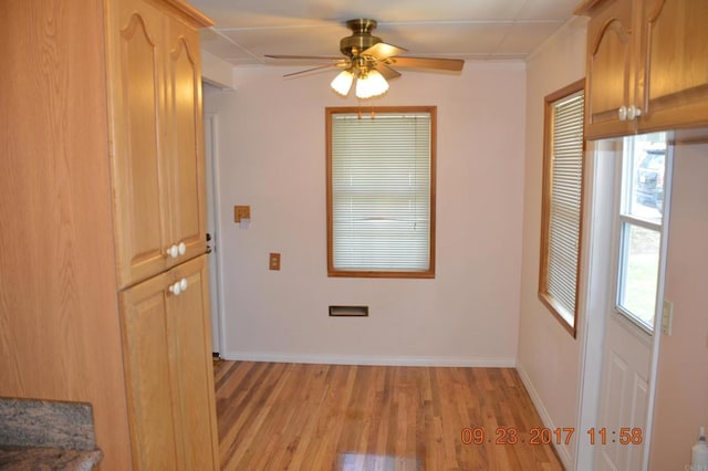 unfurnished room featuring light wood-type flooring and ceiling fan